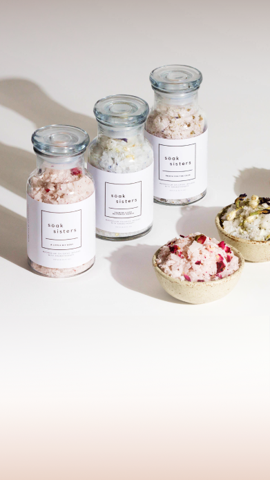 Soak Sisters bath salts displayed in jars and small dishes