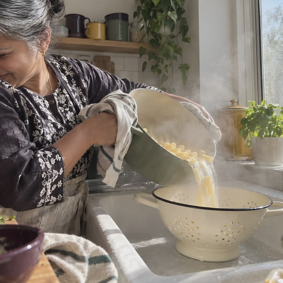 Pasta tipped into the cream KILN Colander in a steaming sink