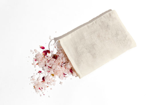Aerial view of bath salts spilling out of cotton muslin bag